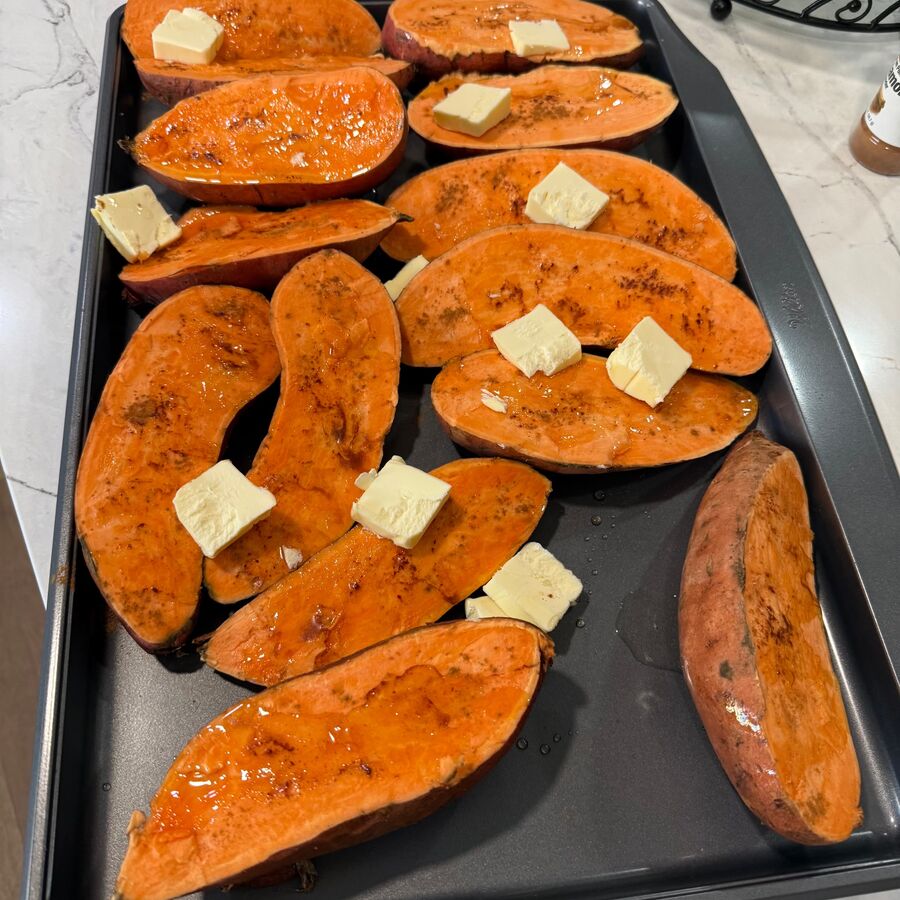 Roasted sweet potatoes with butter on a sheet pan